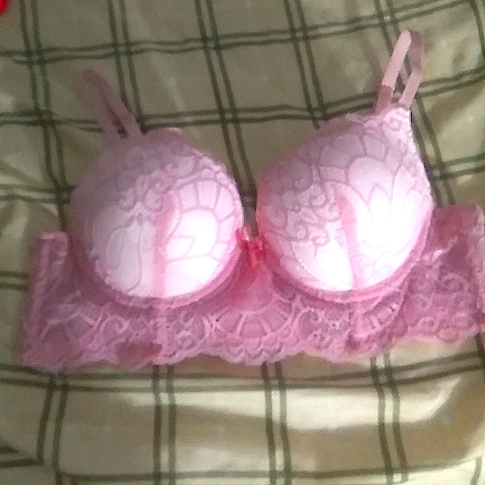 A pink bra with white and pink accents on it.